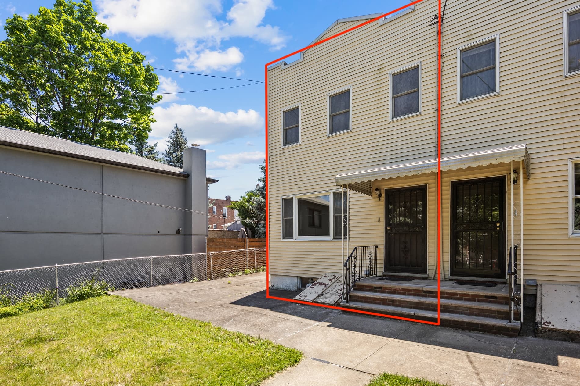 Front exterior of two-family home on 56th Drive in Maspeth